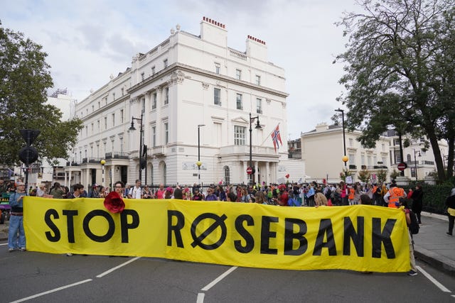 People take part in a protest in central London, holding a large yellow banner with the words 'Stop Rosebank' on it, after the controversial Equinor Rosebank North Sea oil field was given the go-ahead