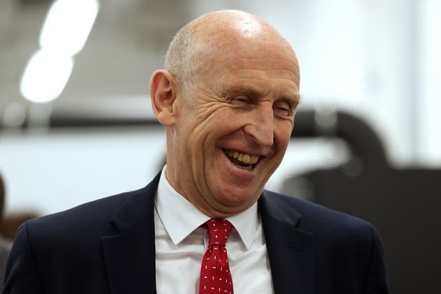 Head and shoulders photo of John Healey laughing