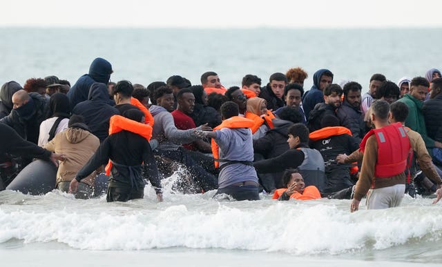 People thought to be migrants scramble to board a small boat in Gravelines, France