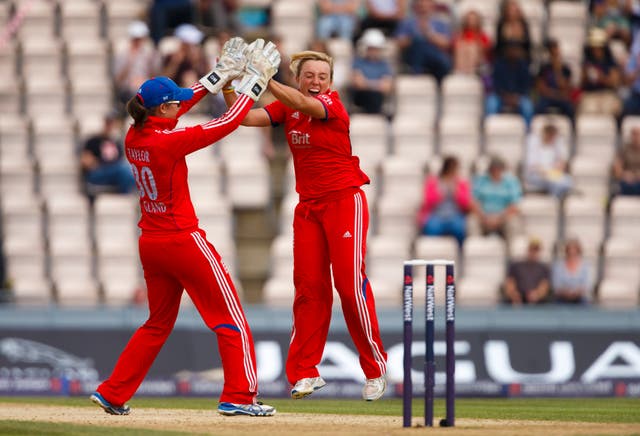 Dani Hazell (right) celebrates a wicket with England team-mate Sarah Taylor (left).