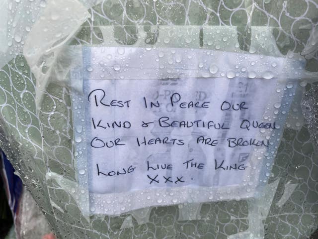 A message left on flowers at the gates of Hillsborough Castle