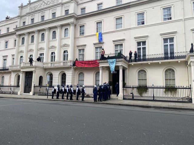 Officers in riot gear entering the mansion on Monday