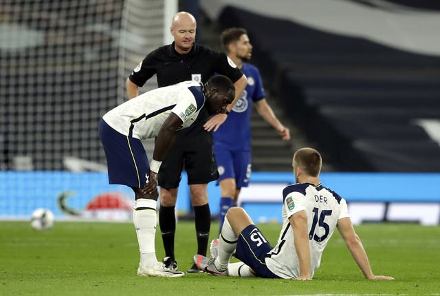 Eric Dier, right, awaits treatment during the win over Chelsea