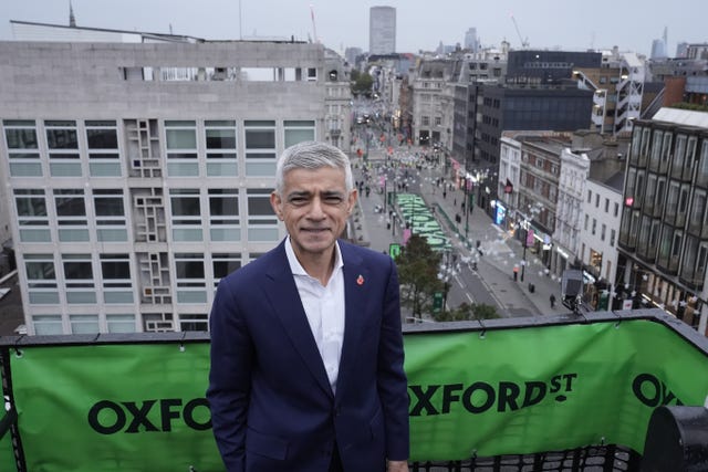 Lord Sadiq Khan stands with Oxford Street in the background