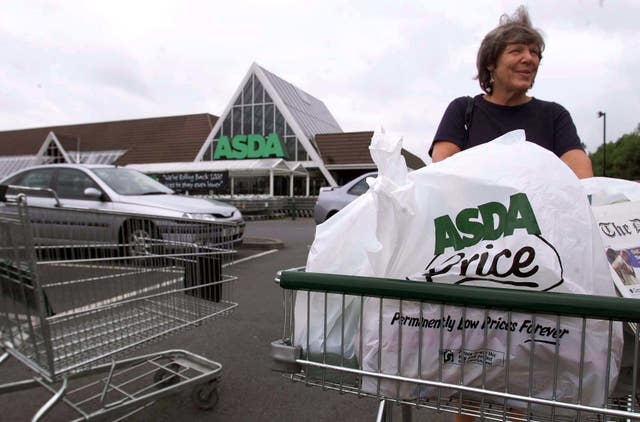 An Asda shopper with plastic bags in a trolley