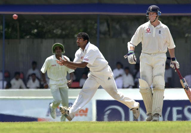 Sri Lankan bowler Muttiah Muralitharan, goes for a catch off his own bowling at the Galle International Stadium