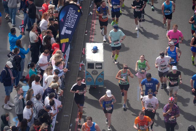 A runner crossing Tower Bridge in a cardboard VW costume