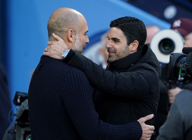 Manchester City manager Pep Guardiola (left) and Arsenal boss Mikel Arteta embrace