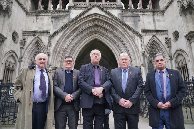 Former students of Treloar’s School, (second left to right) Adrian Goodyear, Richard Warwick, Steve Nicholls, and Gary Webster, accompanied by their legal representative, solicitor Des Collins (left), outside the Royal Courts of Justice 