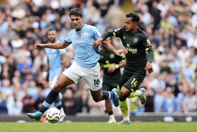 Manchester City’s Rodri (left) battles with Brentford’s Fabio Carvalho for the ball