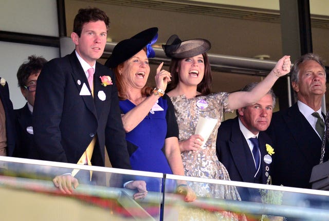 Sarah Ferguson (centre) with Princess Eugenie and Jack Brooksbank cheering on horses at Royal Ascot. Dominic Lipinski/PA Wire