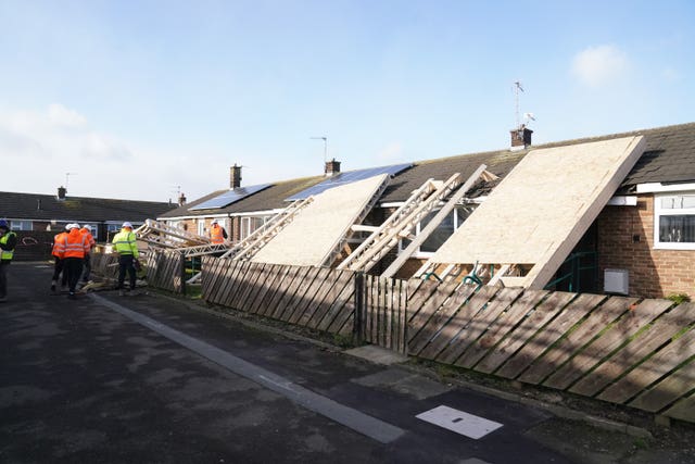 A roof blown off during strong winds rests on some bungalows in Amble, Northumberland