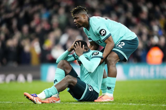 Yerson Mosquera, left, sits on the floor dejected