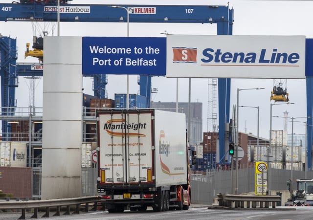 A lorry passes under a sign which says 'Welcome to the Port of Belfast' 