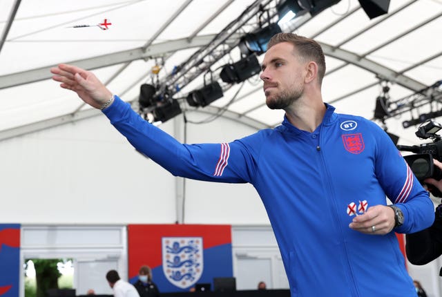 England's Jordan Henderson plays darts after a press conference at St George's Park