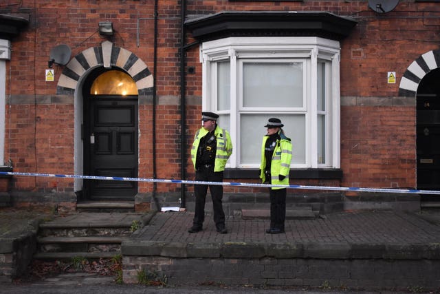 Police officers outside flats in Woverhampton Road, Stafford, where a property is being searched by following Friday's attack