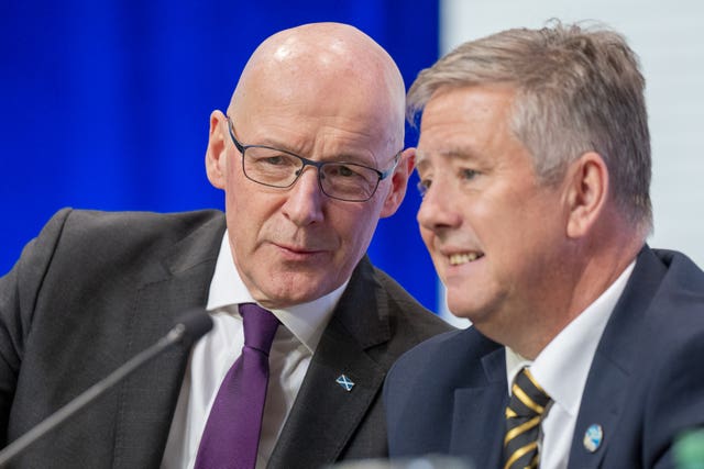 First Minister John Swinney (left) and SNP depute leader Keith Brown speak during the party's annual national conference