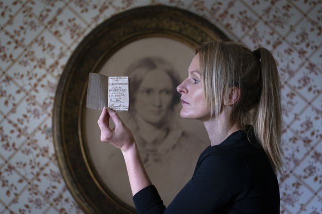 Curator Sarah Laycock with the last Charlotte Bronte miniature manuscript book known to be in private hands, as the book goes on display following its return to the Bronte Parsonage Museum in Haworth, Keighley, West Yorkshire, once the home of the Bronte family 