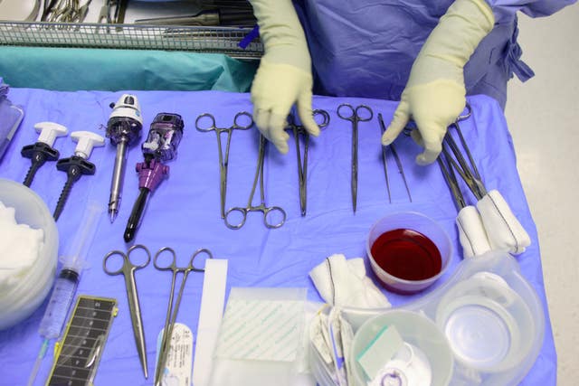 A member of staff checks surgical instruments