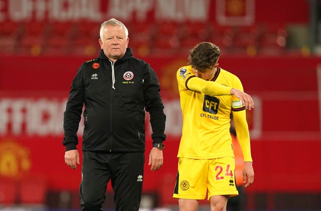 Sheffield United manager Chris Wilder and captain Oliver Arblaster react after defeat to Manchester United