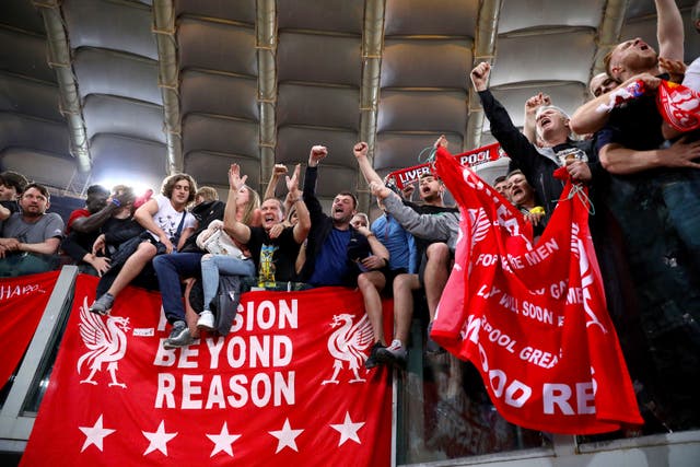 Liverpool fans celebrate after the final whistle (Steven Paston/PA)