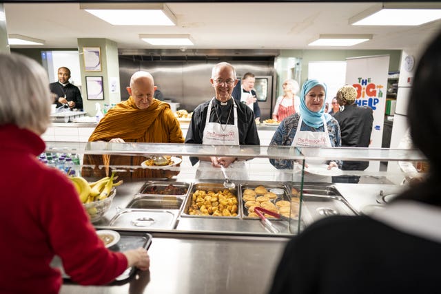 The Archbishop of Canterbury and other faith leaders help serve food 