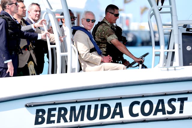 The King takes a trip on a console boat during a visit to the Royal Bermuda Regiment Coast Guard