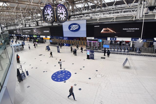 Commuters cross the concourse at London's Waterloo Station on Friday morning