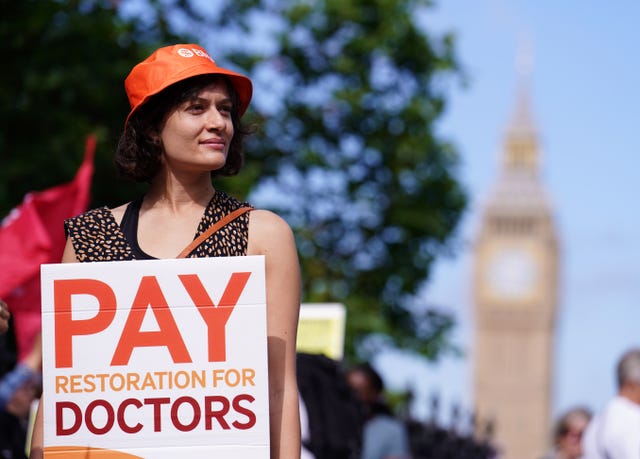 Junior doctor with a protest placard