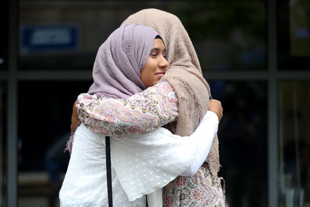 Nadiya Khair, left, is congratulated by her aunt Shaheda Rahmen at Peter Symonds College, Winchester, after opening her A-level results 
