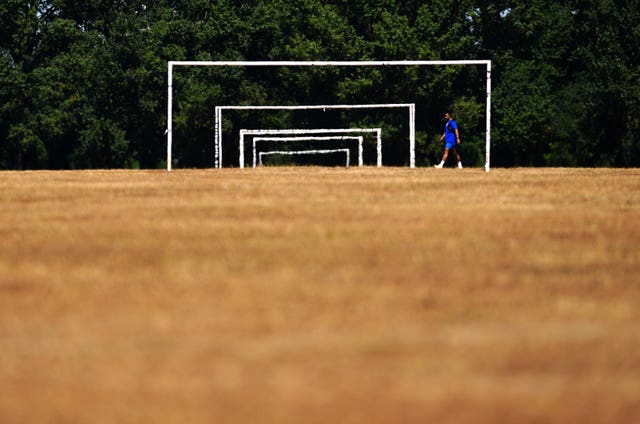 Dry grass and goals on the football pitches at Hackney Marshes