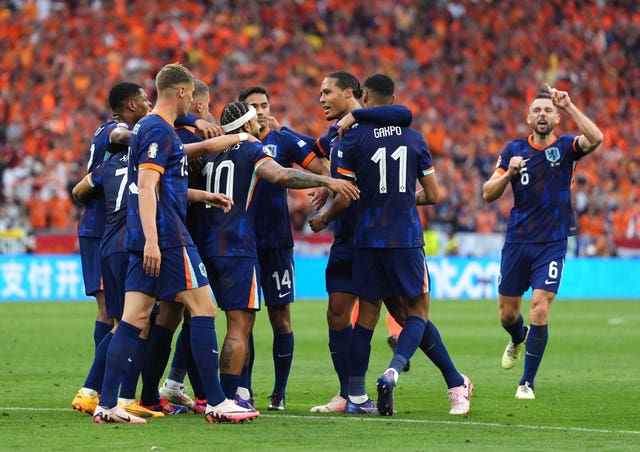 Netherlands players celebrate scoring a goal against Romania