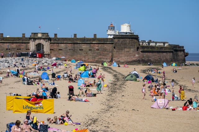 Sunbathers at New Brighton (Peter Byrne/PA)