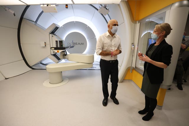 Health Secretary Sajid Javid with Therapeutic Radiographer Laura Allington as he views the proton beam scanner during a visit to University College Hospital in London to mark World Cancer Day