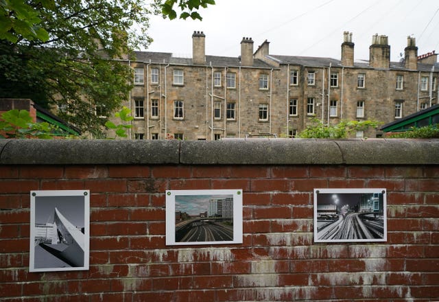 Photographs attached to a wall as part of the exhibition