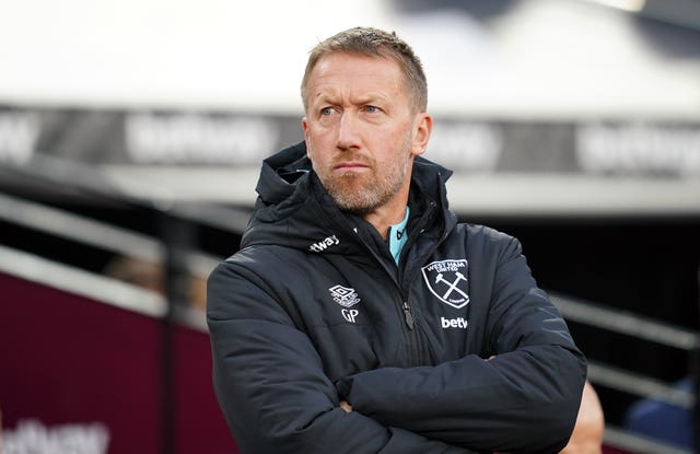 Graham Potter stands with his arms folded