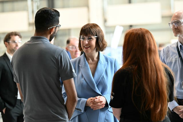 Rachel Reeves, wearing safety glasses, speaks to two apprentices at the National Manufacturing Institute Scotland.