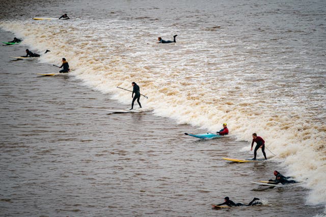 Surfers ride the first five-star Severn Bore of 2024 at Newnham