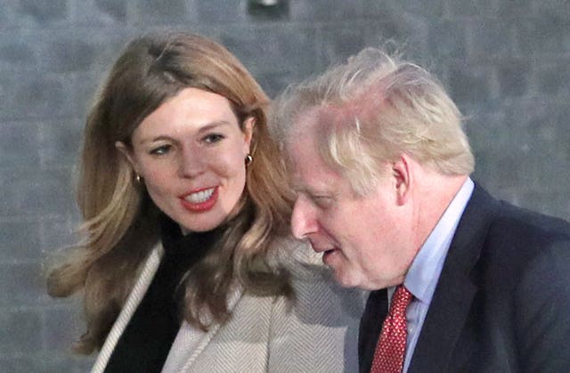 Boris Johnson and his fiancee Carrie Symonds arrive in Downing Street