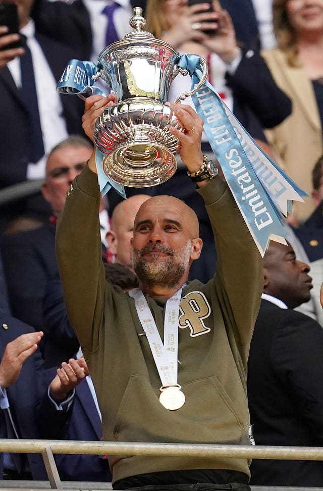 Pep Guardiola lifts the FA Cup