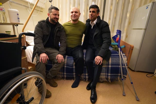 The hands of President Zelensky (left) are clearly unmarked as he and Mr Sunak meet another wounded war veteran during the visit to a hospital in Kyiv on January 12