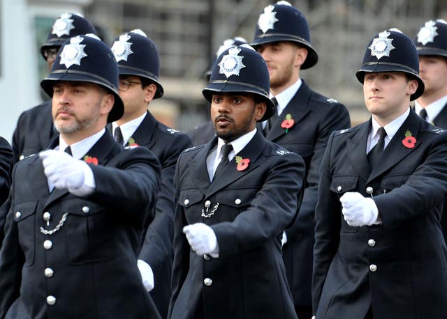 Uniformed police officers marching during a passing out parade.