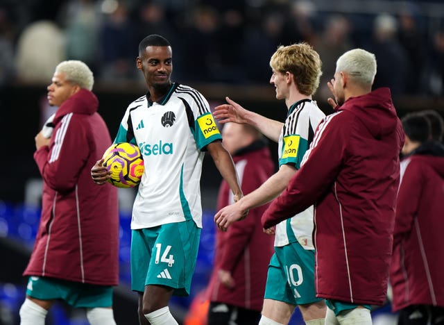 Newcastle striker Alexander Isak, holding the match ball after his hat-trick, celebrates with his team-mates after a 4-0 Premier League win at Ipswich