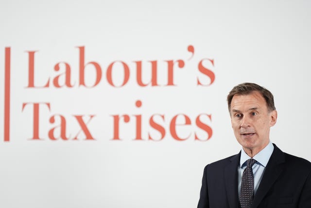 Jeremy Hunt in front of text: Labour's tax rises 