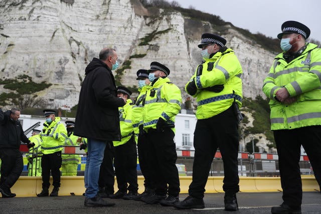 A haulier speaks to police officers blocking the entrance to the Port of Dover