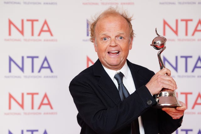 Toby Jones holds his award