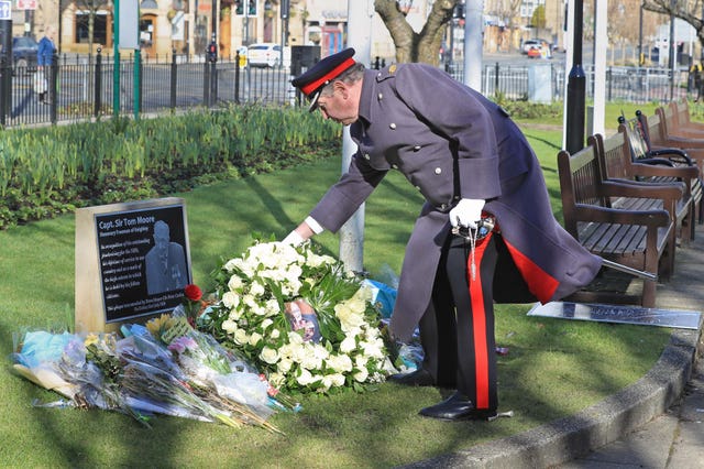 David Pearson, Deputy Lieutenant for West Yorkshire, lays a wreath of 200 white roses at the Sir Tom Moore memorial plaque in Keighley, West Yorkshire, on the day of Captain Sir Tom Moore’s funeral in February