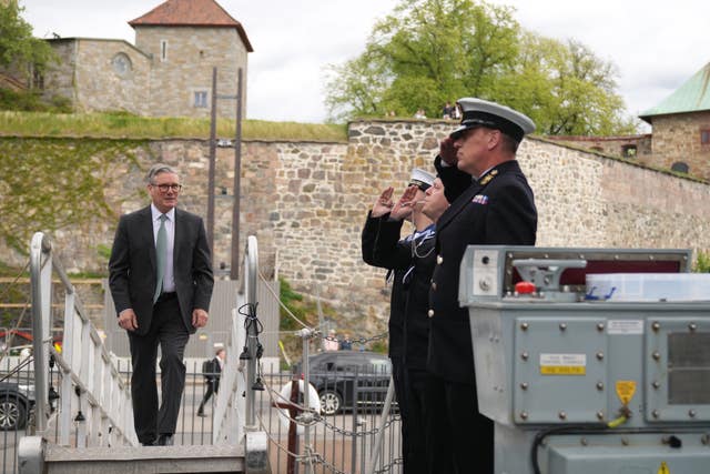 Members of the Royal Navy salute Sir Keir Starmer on the HMS St Albans