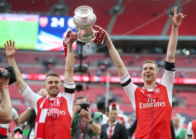 Arsenal skipper Per Mertesacker, right, and match-winner Aaron Ramsey celebrate at Wembley three years ago