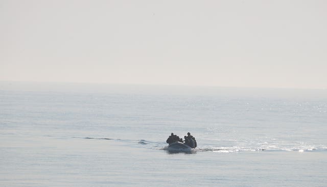 A group of people thought to be migrants arrive in an inflatable boat at Kingsdown beach, near Dover, Kent (Gareth Fuller/PA)